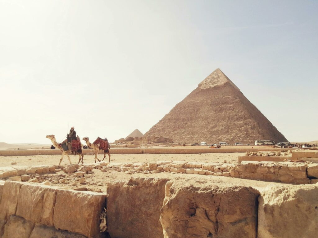 pexels photo 3958516 3958516 Explore the iconic Giza Pyramids with camels in the foreground, capturing Egypt's rich history.